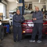 Jesus Rojas, right, and Raul Man Perez, left, co-owners of J & R Auto Repair are photographed in their shop in San Francisco, on Thursday, May 12, 2022. Photo by Nina Riggio for CalMatters