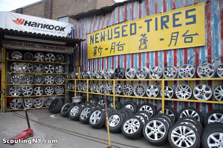 Various wheels lining the shelves in an auto body repair shop