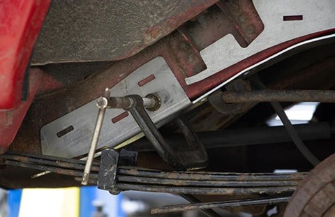 Rust Buster repair parts being installed on to the frame of a vehicle