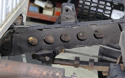 Rust Buster frame boxing plate installed on the frame of a Toyota Tacoma