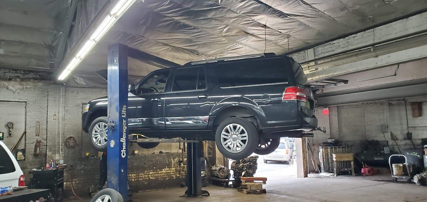 auto mechanic working on car