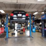 Mechanic performing diagnostics on a car engine, symbolizing the problem-solving aspect of the profession