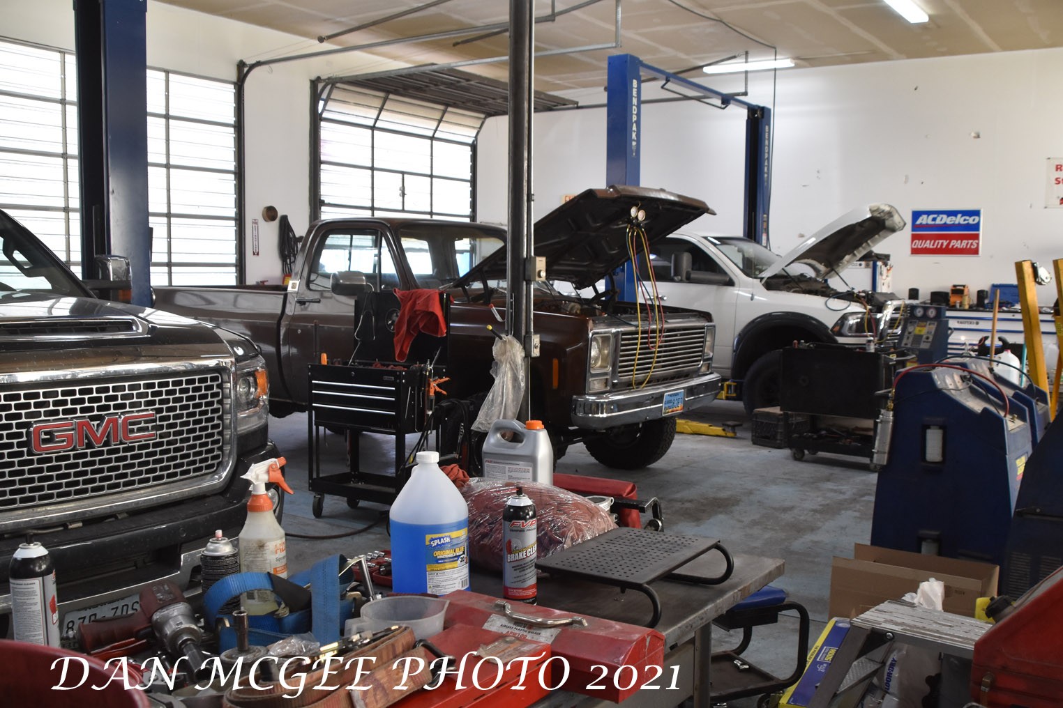 The shop is a busy place with several vehicles getting service and or repairs, highlighting the potential for a successful auto repair business.