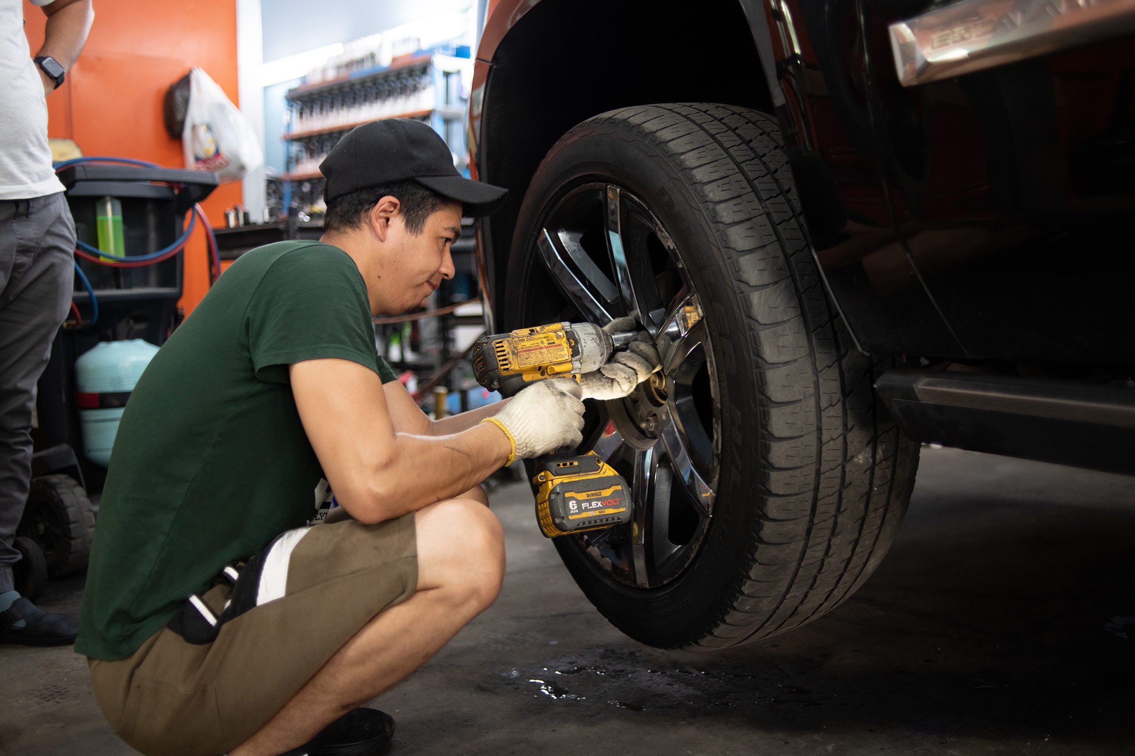 Mechanic inspecting engine bay, showcasing automotive repair skills