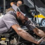 Mechanic at The Auto Repair performing maintenance