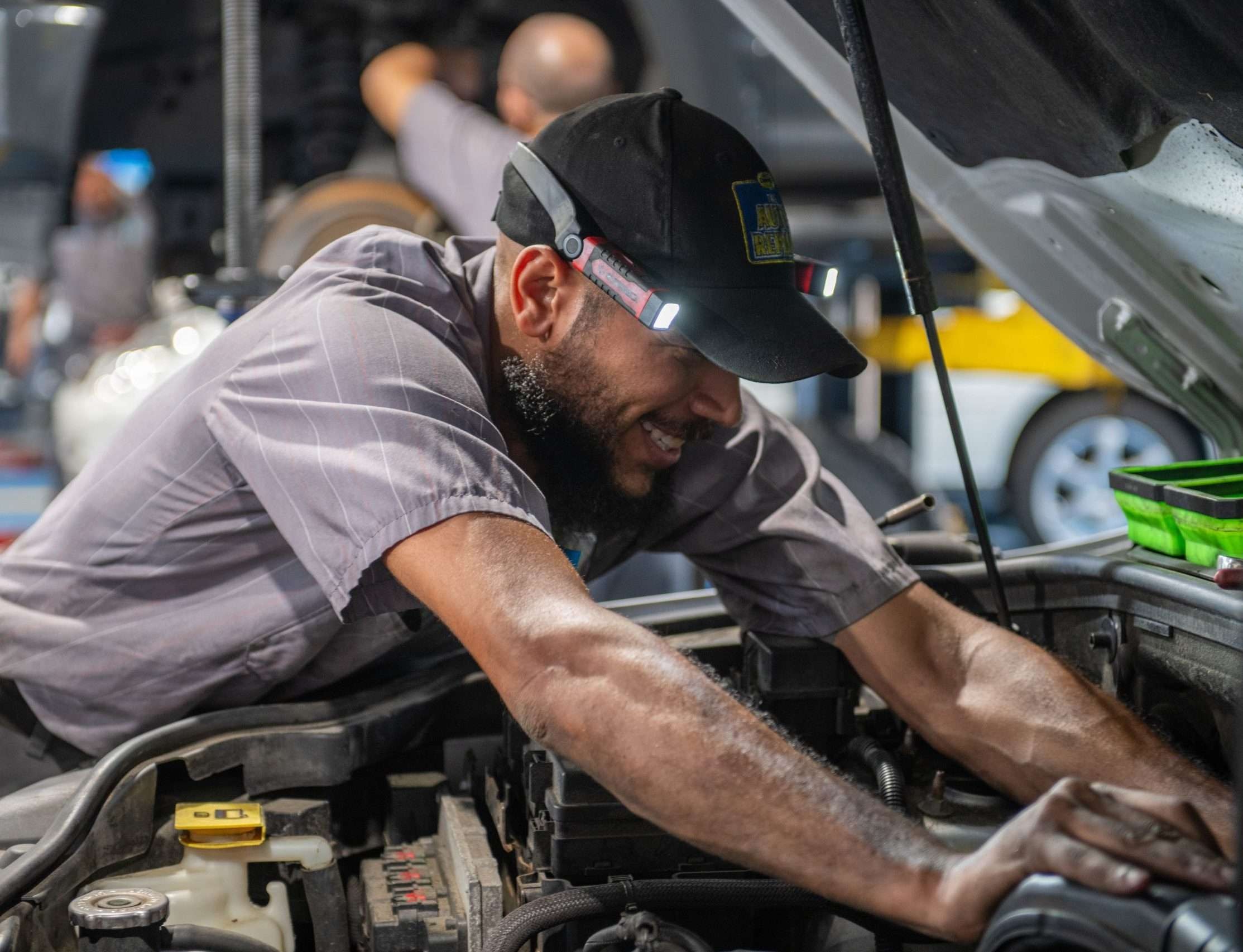 Mechanic at The Auto Repair performing maintenance
