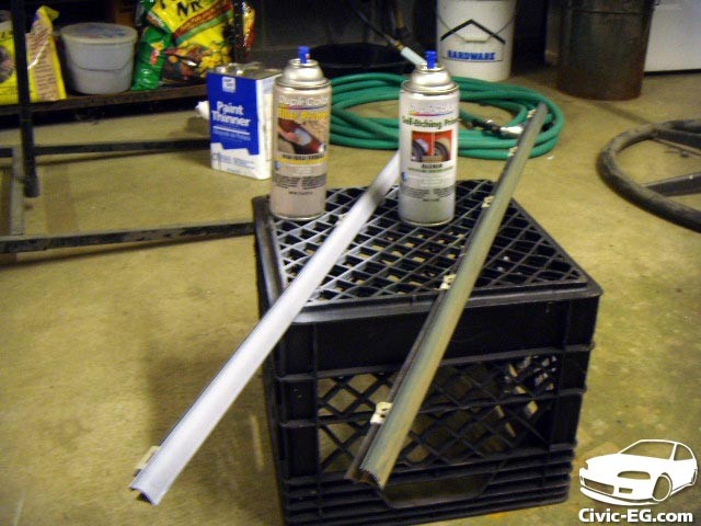 Applying primer to the sanded auto window trim to prepare it for painting