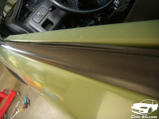Restored car window trim after repair and painting, showcasing a professional, like-new finish