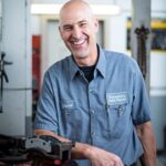 Auto Mechanic Working On A Car Engine