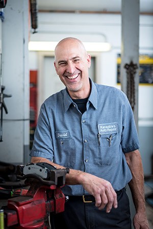 Auto Mechanic Working On A Car Engine