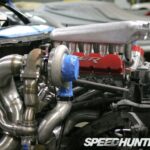 Technician using diagnostic tools on a turbocharger system, emphasizing the blend of technology and hands-on skills required.