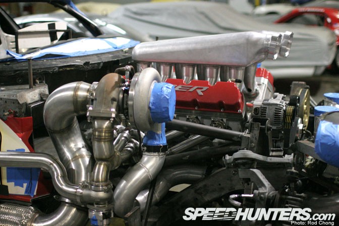 Technician using diagnostic tools on a turbocharger system, emphasizing the blend of technology and hands-on skills required.