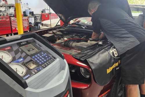 Technician working on car AC
