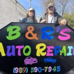 Jenny Helinski, left, and Bill Lancewicz stand next to the sign for their new business, B&S’s Auto Repair, on Friday, representing their commitment to the Alpena community.