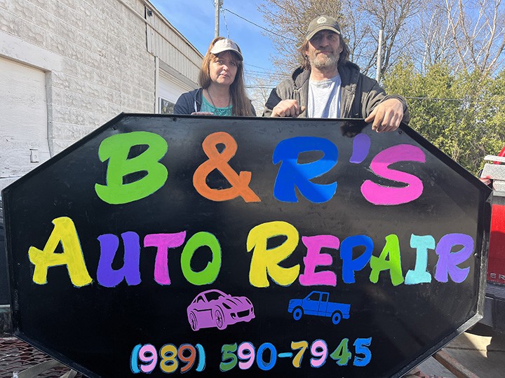 Jenny Helinski and Bill Lancewicz stand next to the sign for their new business, B&S’s Auto Repair, on Friday showing their commitment to the Alpena community