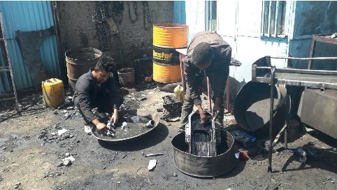 Vehicle Repair Workers Cleaning Parts