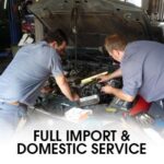 Technician working on car engine