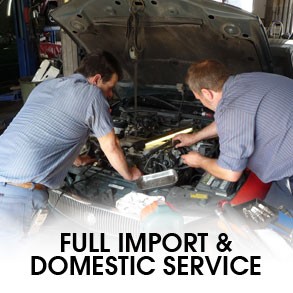 Technician working on car engine