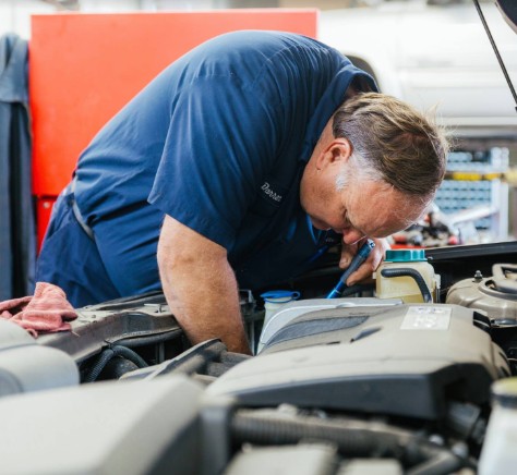 Technician Working on Car